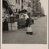 Background photograph for Hightstown project. Play street for children. Sixth Street and Avenue C, New York City. The Solomon family who are to be resettled at Hightstown, live in this neighborhood. This Resettlement Administration project includes two hundred and fifty homes, four hundred and fourteen acres of farmland, a modern factory, utilities, including water system, recreation area and lake. Each family will have a modern home and an opportunity to work in a cooperative factory. Also a small plot of land for raising garden vegetables