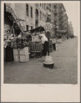 Background photograph for Hightstown project. Play street for children. Sixth Street and Avenue C, New York City. The Solomon family who are to be resettled at Hightstown, live in this neighborhood. This Resettlement Administration project includes two hundred and fifty homes, four hundred and fourteen acres of farmland, a modern factory, utilities, including water system, recreation area and lake. Each family will have a modern home and an opportunity to work in a cooperative factory. Also a small plot of land for raising garden vegetables