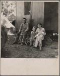 Marysville migrant camp. California fruit tramp and his family (mother, twenty-two years old)