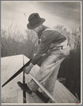 Carpenter working on the roof of the first shelter near the lake site of the Berwyn project, [Greenbelt,] Maryland.