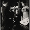 Ray Milland [center] and unidentified others in the stage production Hostile Witness
