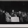 Shirley Booth [seated], Melvyn Douglas [standing at center] and unidentified others in the stage production Juno