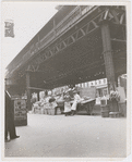 Street vendors underneath the elevated train line near the corner of West 145th Street and Ninth Avenue, Harlem, New York, 1939