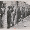 Spectators behind a chain-link fence watching a sandlot baseball game at West 125th Street and Morningside Drive, Harlem, New York City, 1946