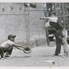 Catcher Robert Smith and batter Howard Dicks during baseball practice on playground at West 134th Street and Eighth Avenue, Harlem, New York City, 1949
