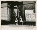 Sidewalk sitters. Two women sitting in doorway of empty storefront that is being offered for rent, Harlem, New York City, ca. 1930s
