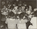 Groups of children eating at tables