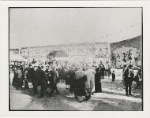 C.W. Parker Amusement Company operated carnival, ca. 1920s. Signage for burlesque shows, as well as groups of stage performers, are in the far background