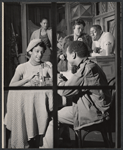 Billie Allen [seated left at table], Anita Cipriani [standing in background], Godfrey Cambridge [seated right at table], Bill Gunn [wearing white top behind counter] and unidentified [middleground wearing fur coat] in the stage production Take a Giant Step
