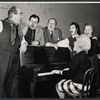 Donald Wolfit, Eugene Roche, John Sharp, Hazel Douglas, Marjorie Rhodes, and unidentified woman playing piano in the stage production All in Good Time