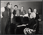 Donald Wolfit, Eugene Roche, John Sharp, Hazel Douglas, Marjorie Rhodes, and unidentified woman playing piano in the stage production All in Good Time