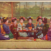 Maiko in screened pavilion, practicing sake service.