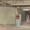 Women bowing to each other in entryway.