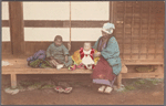 Family seated on a bench.