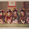 Maiko sitting seiza-style with hands crossed on the floor.