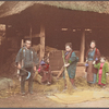 Rural people in front of barn.