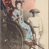 Studio portrait of young woman in ricksaw posed with driver.