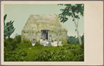 Family in front of Nipa hut.
