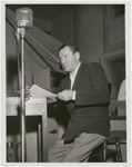 Publicity photograph of Herbert Marshall recording the radio program "The Man Called X."