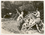 Summer vacation camp, 1924 : close up of scouts building a shelter.