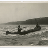 Man and woman canoeing in a river.