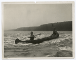 Man and woman canoeing in a river.