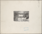 Interior of room with man seated at table and woman coming down stairs
