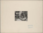 Robert Louis Stevenson and others dining, wearing leis (garlands), and seated on floor