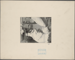Robert Louis Stevenson seated in bed playing a woodwind instrument