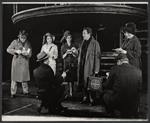 Alec Guiness [center] and ensemble in the stage production Dylan