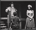 Willoughby Goddard [standing left], Hope Jackman [standing right] and unidentified [with back turned to camera in foreground] in the stage production Oliver!