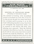 Control of incendiary bomb. (Pouring on sand from scoop).