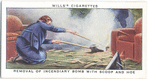 Removal of incendiary bomb with scoop and hoe.