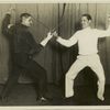 Spain's champion duellist arrives for an American invasion, New York City : Señor Juan Romero, Spain's youthful champion swordsman, who is here to test the metal of America's best, keeps in condition by fencing with Prof. Tonis Senac (left) with whom he is shown duelling.