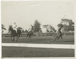 Three polo players approaching sideboard.