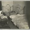 Dark bedroom showing 3 beds and baby carriage