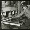 Man operating a brick oven