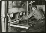 Man operating a brick oven