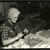 Woman tieing string to glass bottles