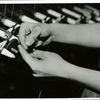 Textile workers tying broken threads by hand