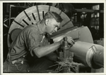 Skilled mechanic using micrometer to measure (to 1/1000 of one inch) the drive shaft he is fashioning