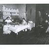Doing piece work at home while father watches, New York tenement