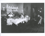 Doing piece work at home while father watches, New York tenement