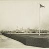 View of the New York skyline from Ellis Island. The Woolworth Building (the tallest building, at left) is under construction, which dates the photograph as c. 1912-13.