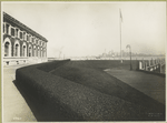 View of one wing of the Immigration Station, Ellis Island, showing New York skyline in the distance.