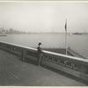 A derby-topped gentleman observing the harbor form the observation roof on one wing of the Immigration Station. The gentleman is possibly William Williams, Commissioner of Immigration at Ellis Island form 1902-5 and 1909-13, from whose estate these photographs came. The New York skyline, showing the nearly-completed Woolworth Building tower, is at the left.