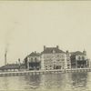 Another view of Ellis Island from the harbor, showing various buildings.