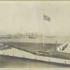 View of Ellis Island lawn, with New York skyline in distance.