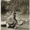Taos, N.M., girl washing an Apache basket, 1926