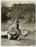 Taos, N.M., girl washing an Apache basket, 1926.